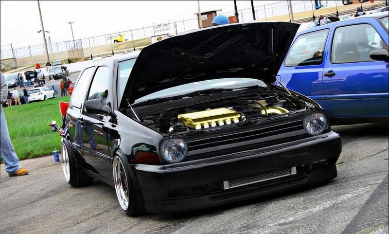 Black car with open hood at show