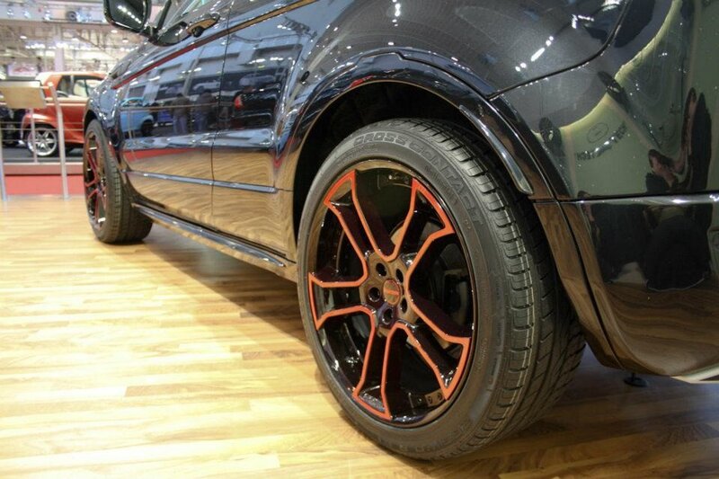 black car with orange rims
