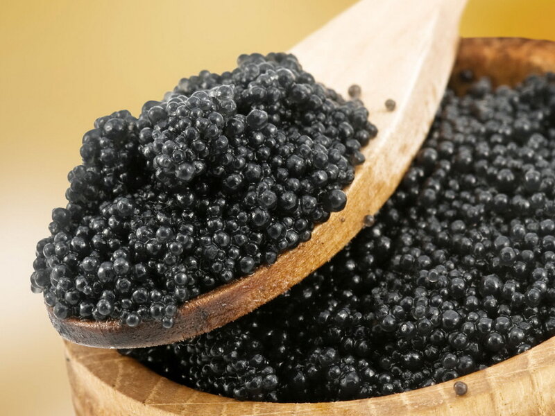 Black caviar in a wooden bowl
