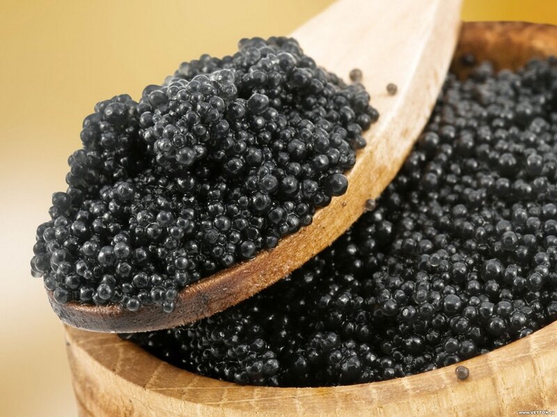 black caviar in wooden bowl