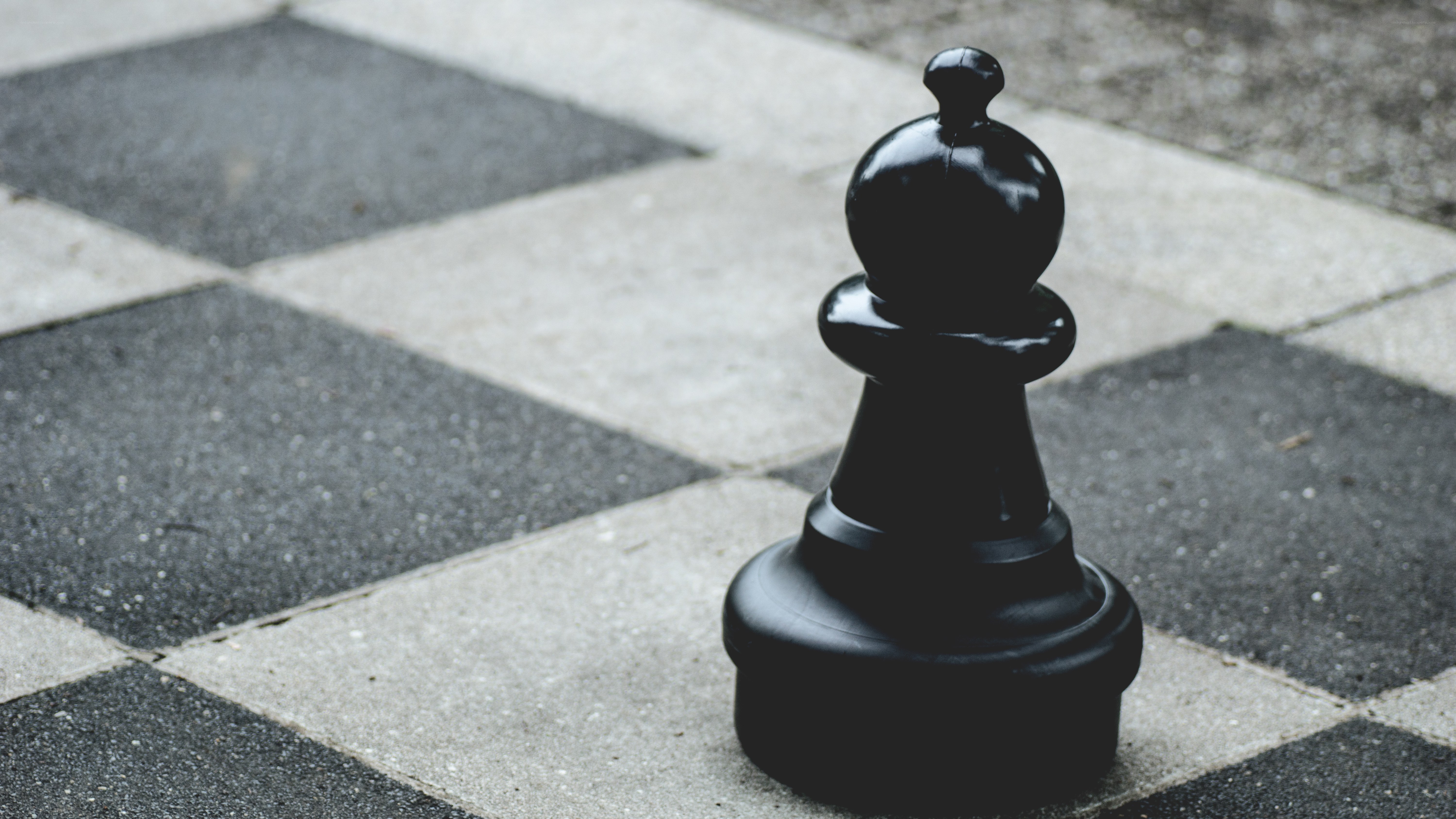 Black chess pawn on board