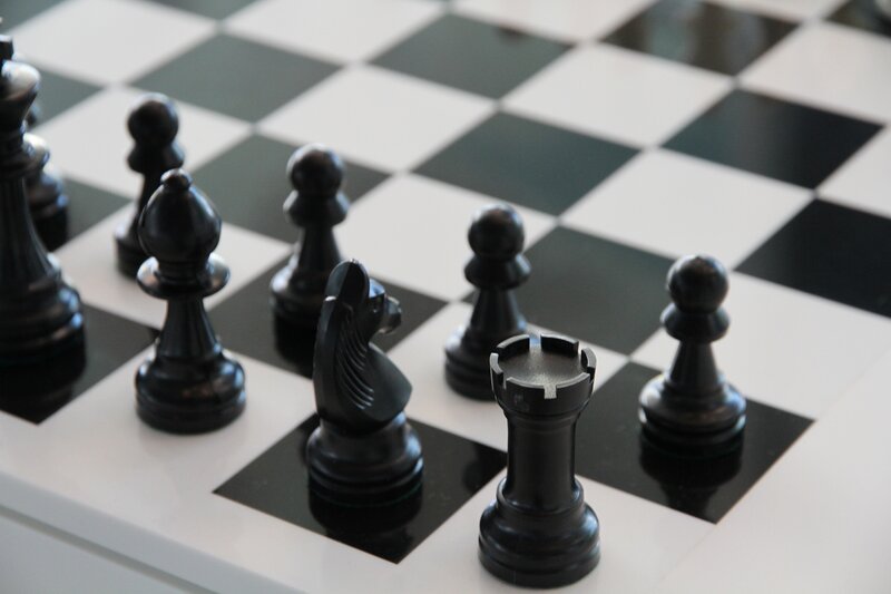 Black chess pieces on a board