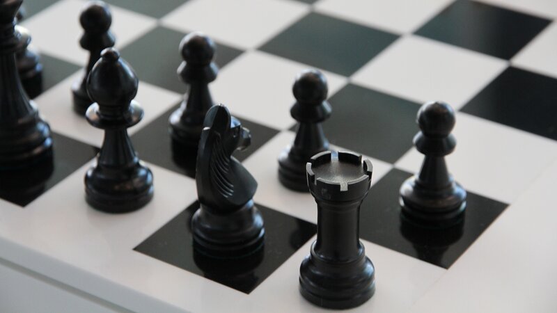 Black Chess Pieces on Board