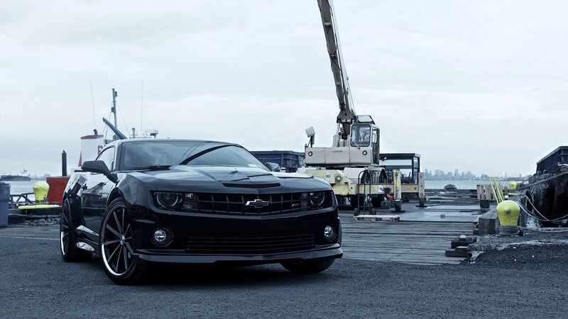 Black Chevrolet Camaro at a port