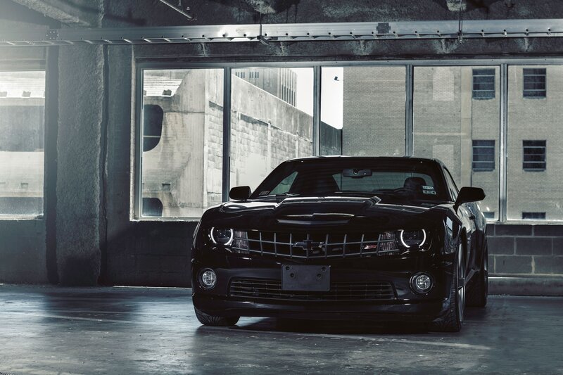 Black Chevrolet Camaro in garage