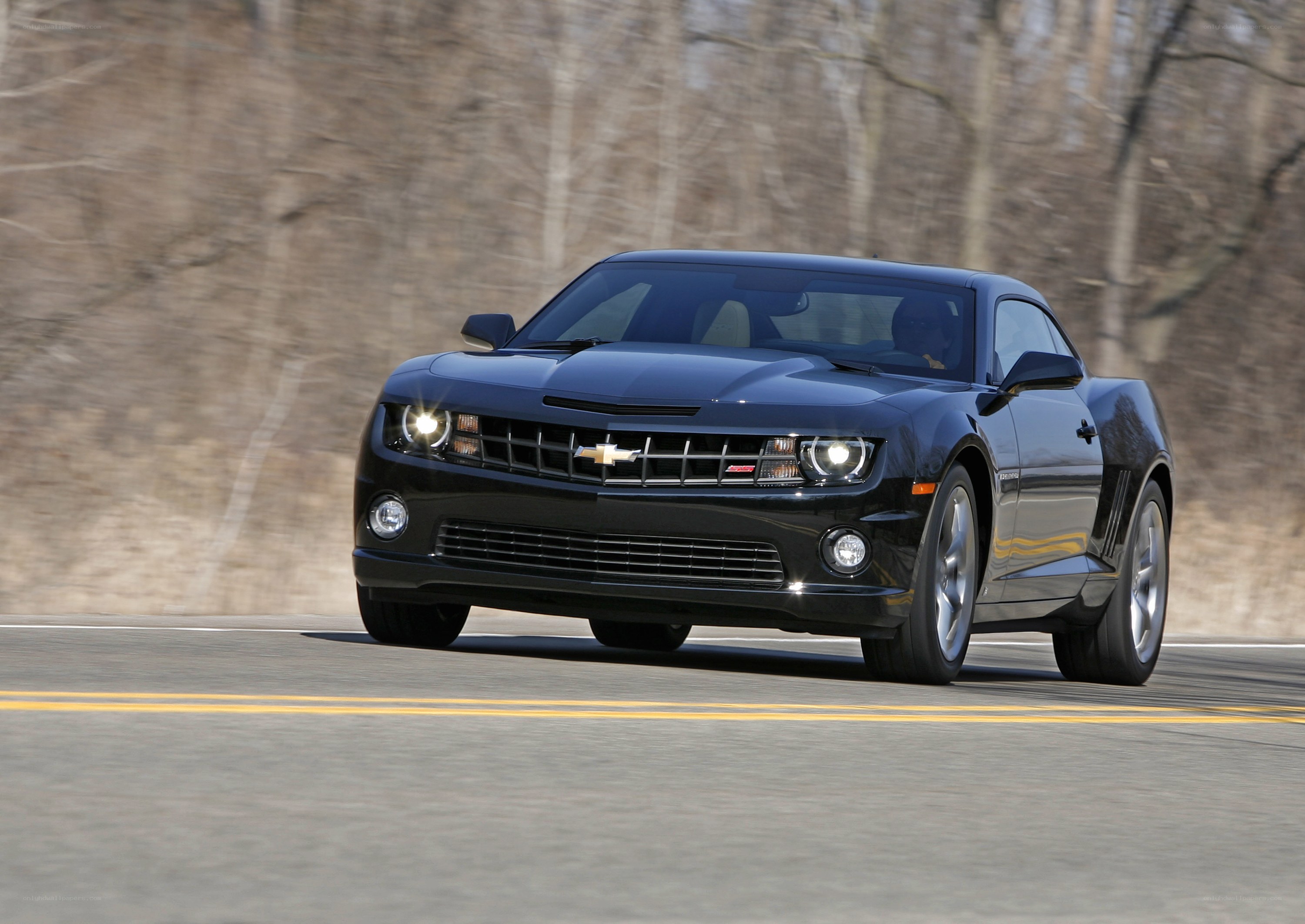 black chevrolet camaro in motion