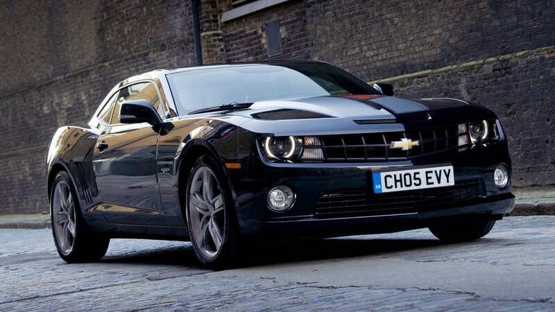 Black Chevrolet Camaro on cobblestones