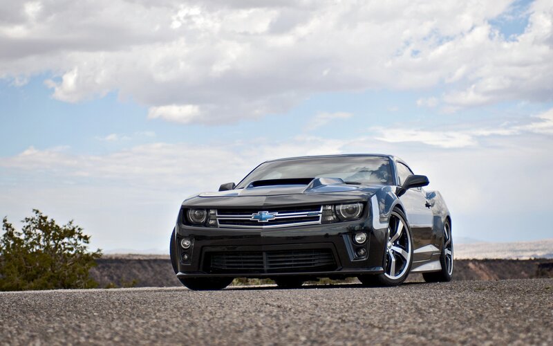 Black Chevrolet Camaro on desert road