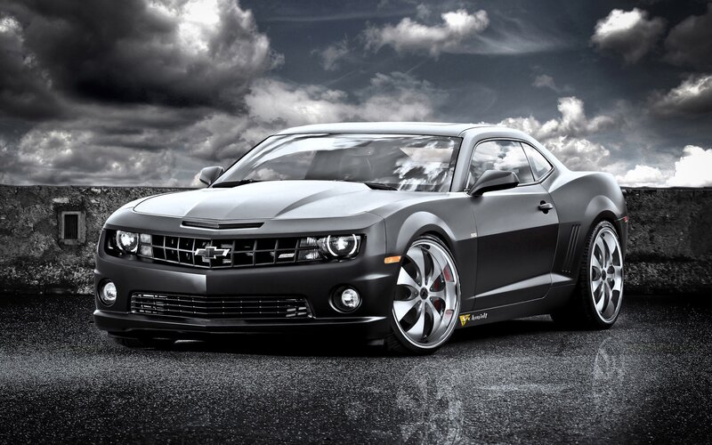 Black Chevrolet Camaro on wet road