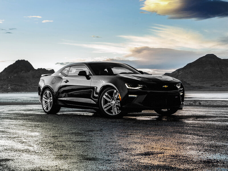 Black Chevrolet Camaro on wet road