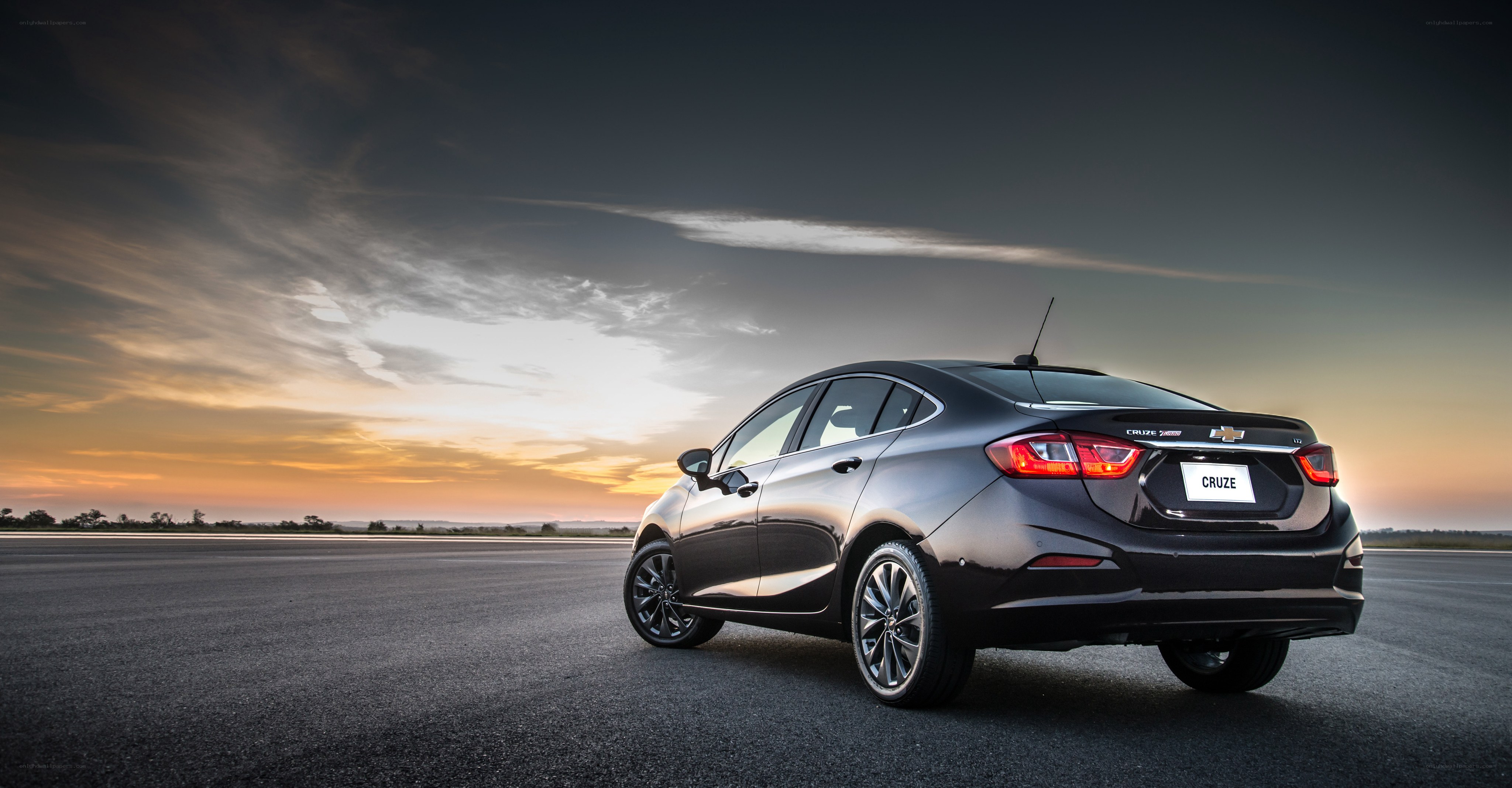 Black Chevrolet Cruze at sunset