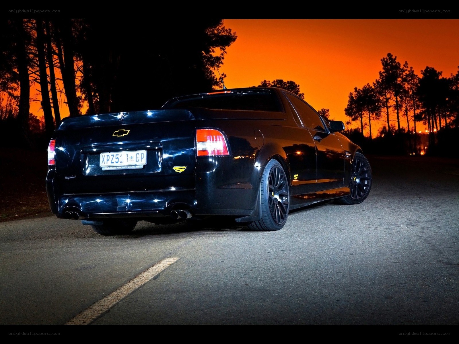 black chevrolet utility at sunset