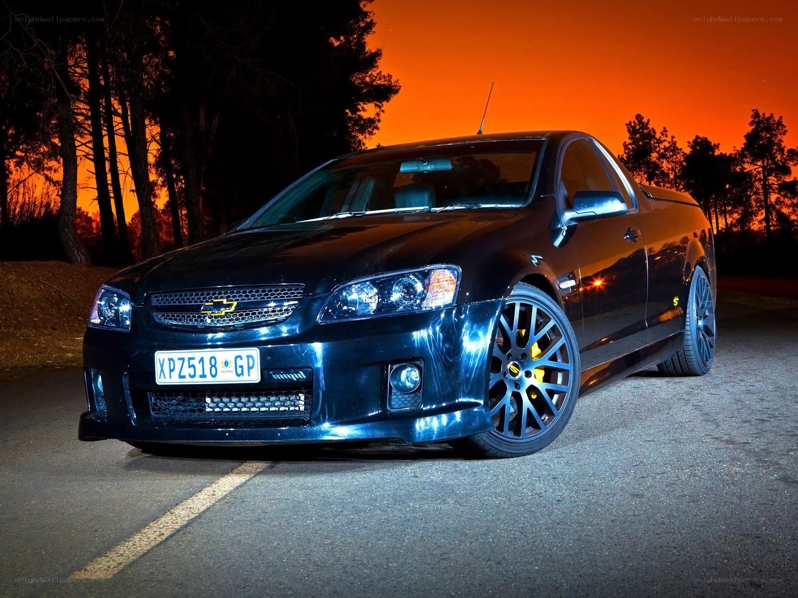 Black Chevrolet utility at sunset