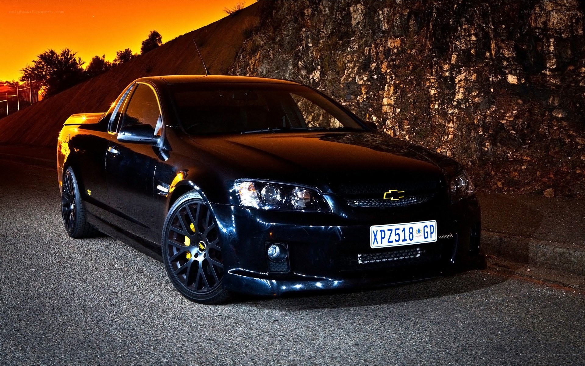 black chevrolet utility at sunset