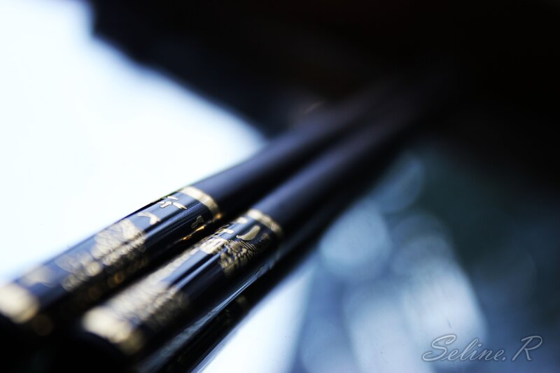 Black chopsticks with gold details