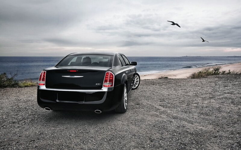 Black Chrysler 300 by the ocean