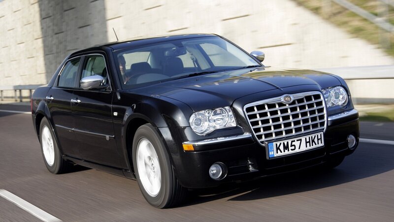 black chrysler 300 driving on road