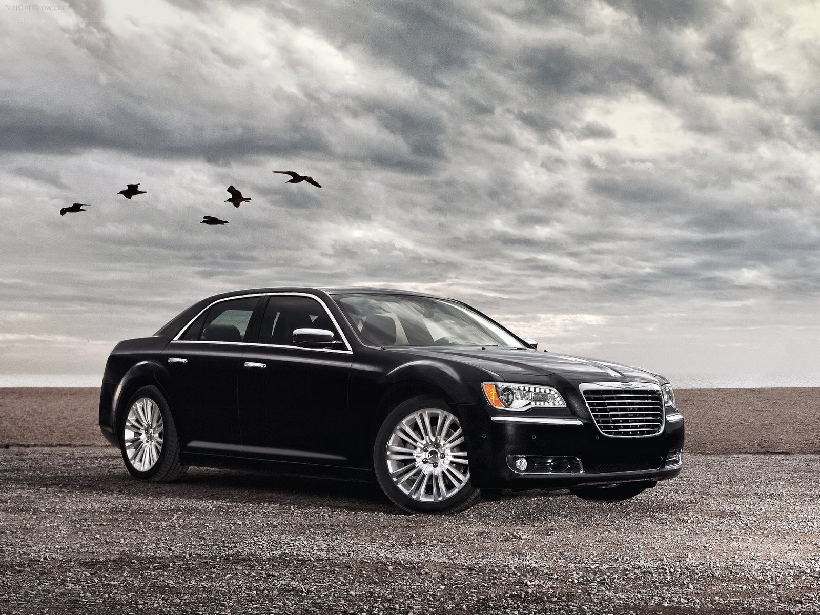 Black Chrysler 300 on a beach