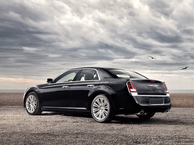 Black Chrysler 300 on a beach