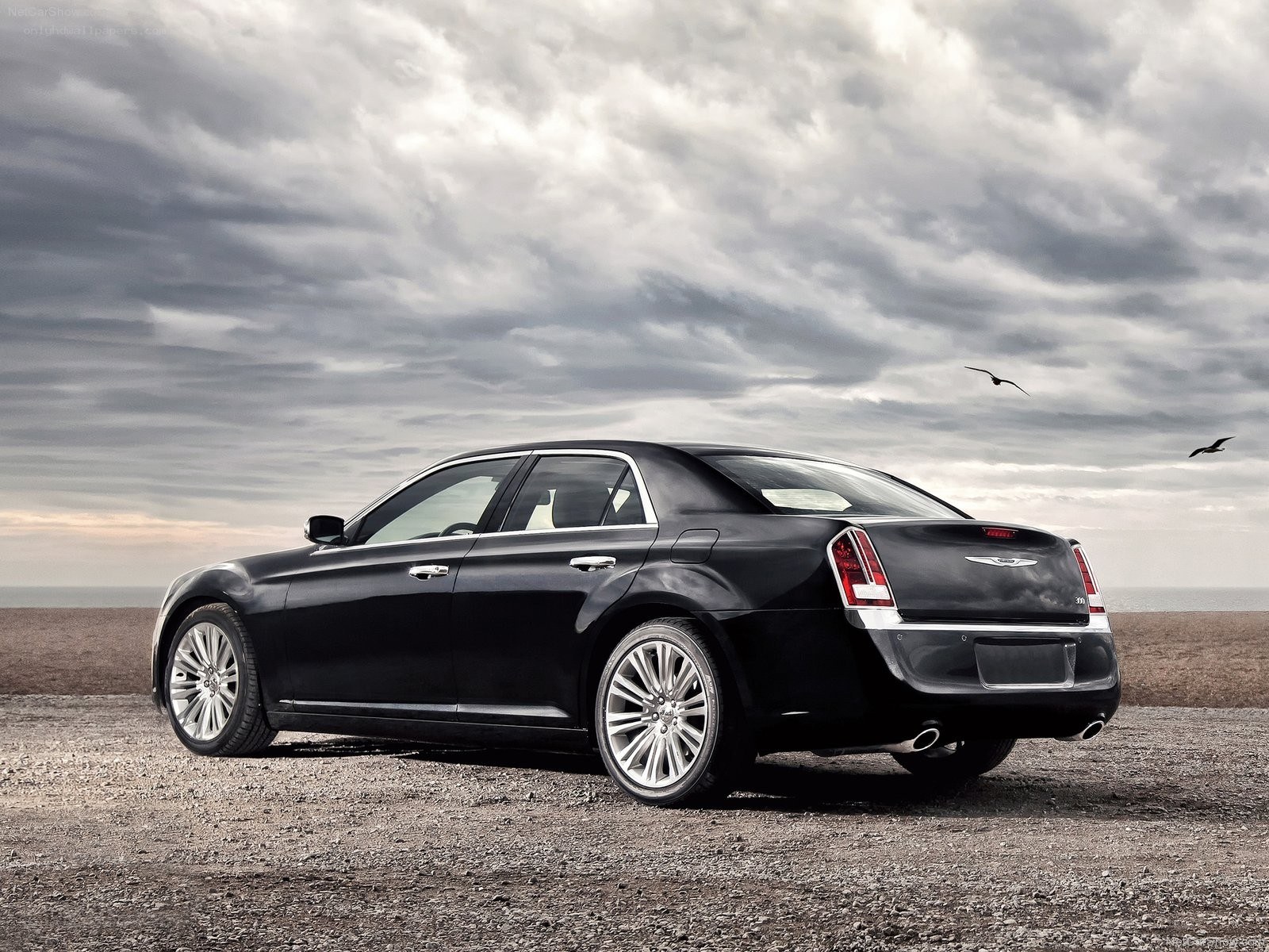 Black Chrysler 300 on a beach