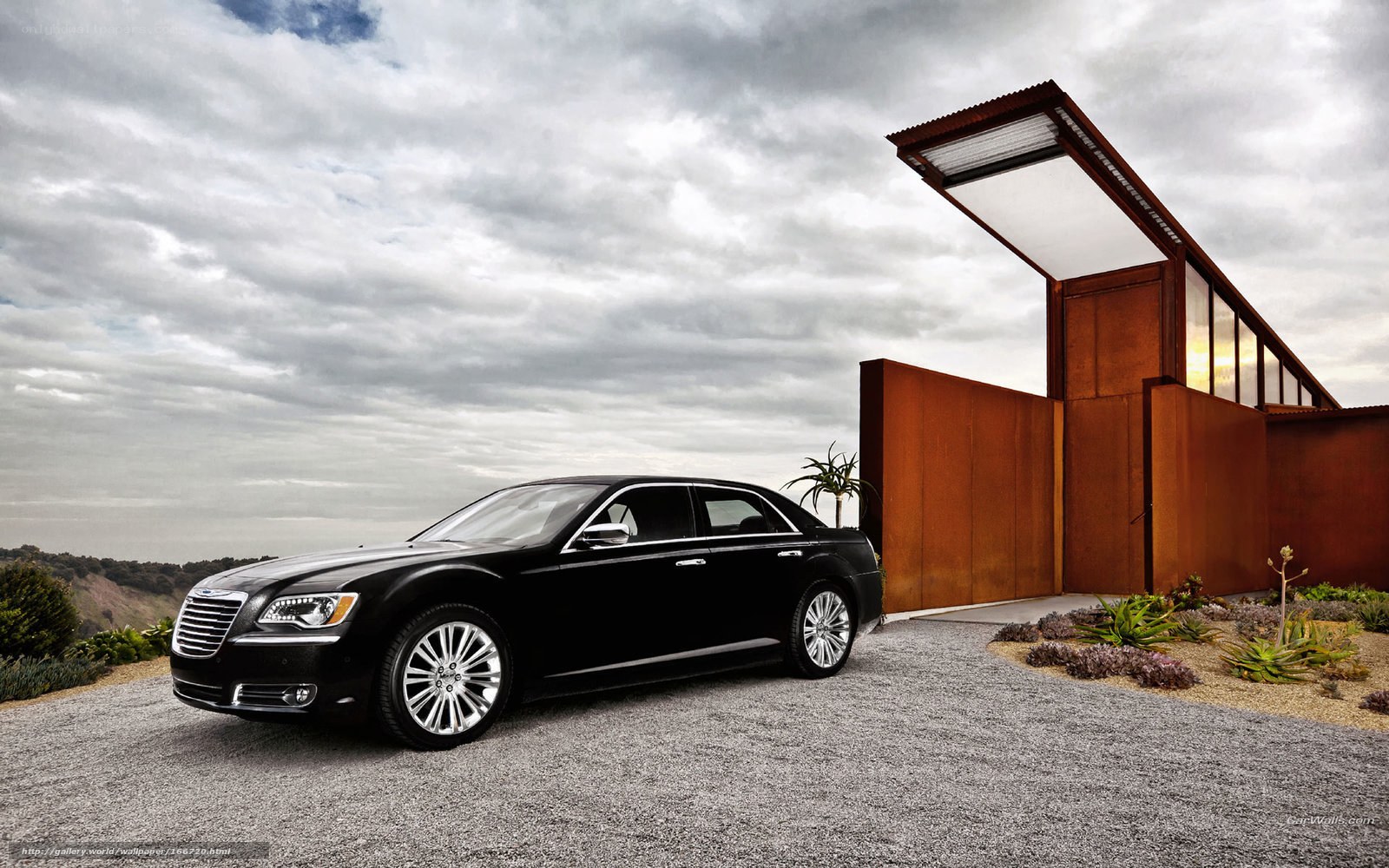 Black Chrysler 300 parked outside modern house