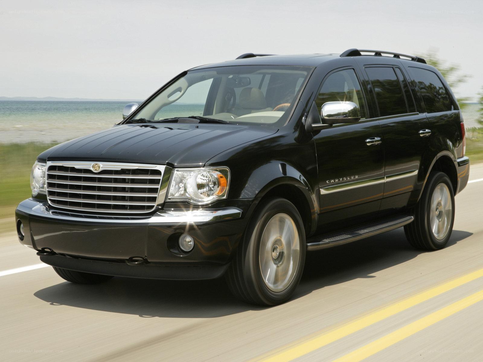 Black Chrysler Aspen driving on road
