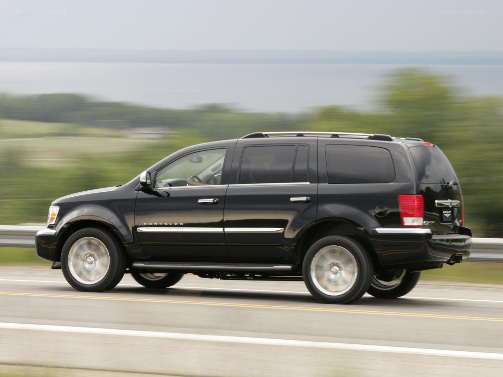 black chrysler aspen suv driving