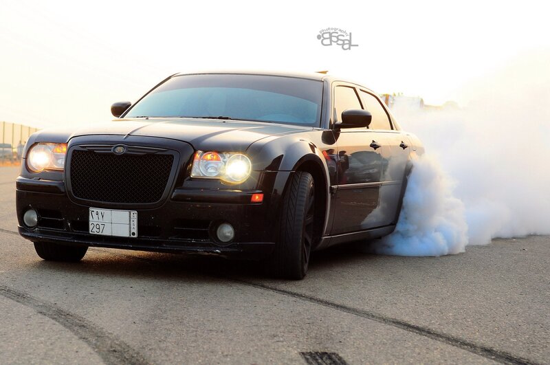 black chrysler doing a burnout