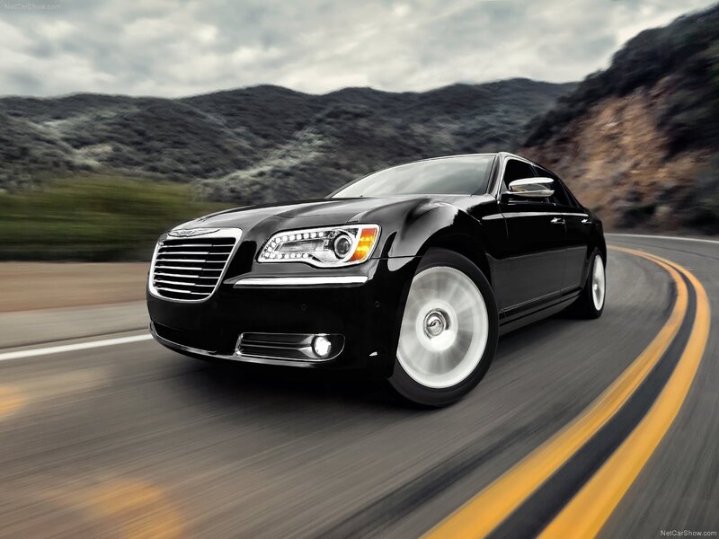 Black Chrysler driving on a road