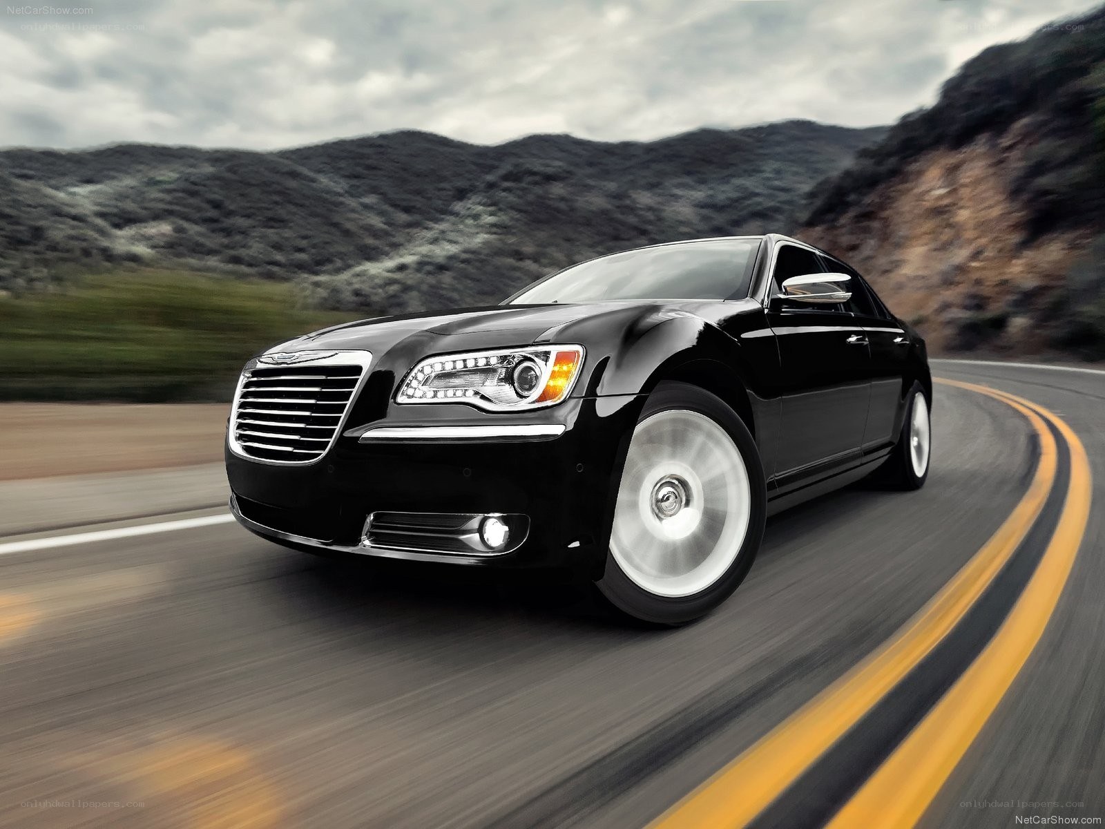 Black Chrysler driving on a road