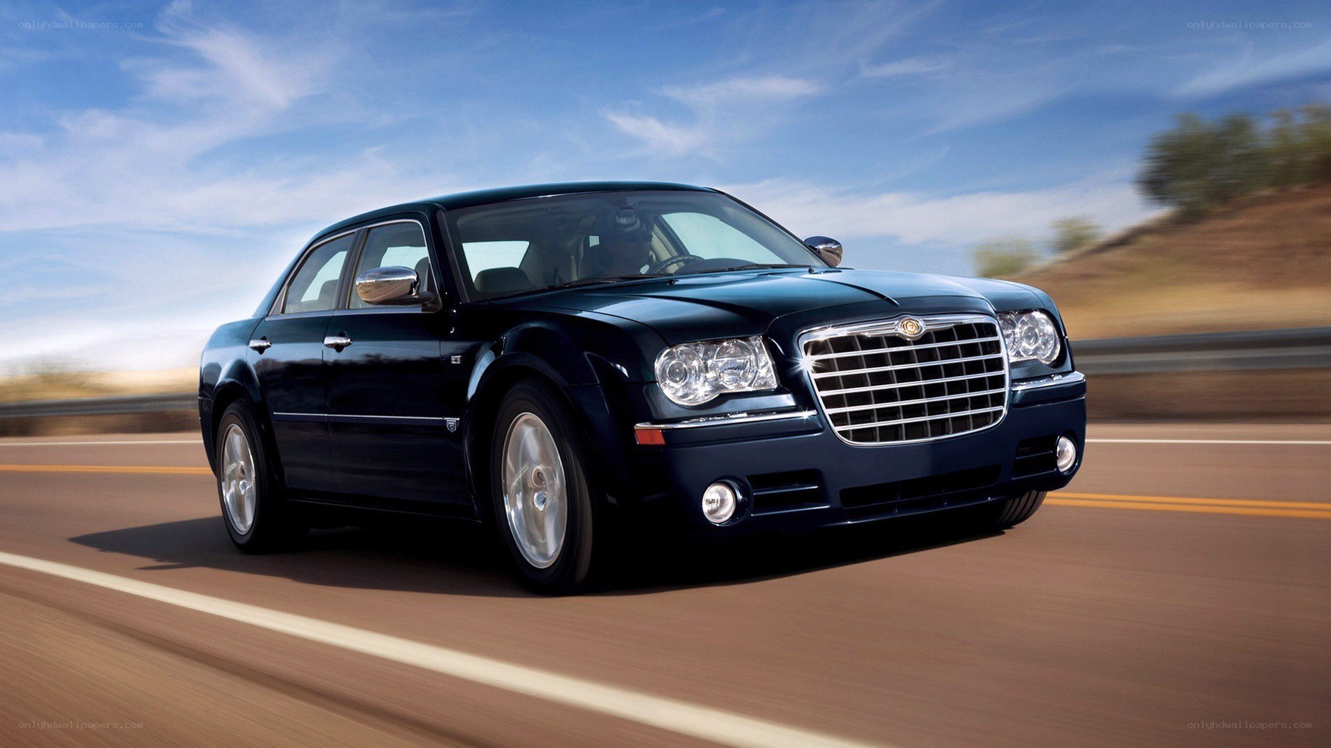 Black Chrysler driving on road