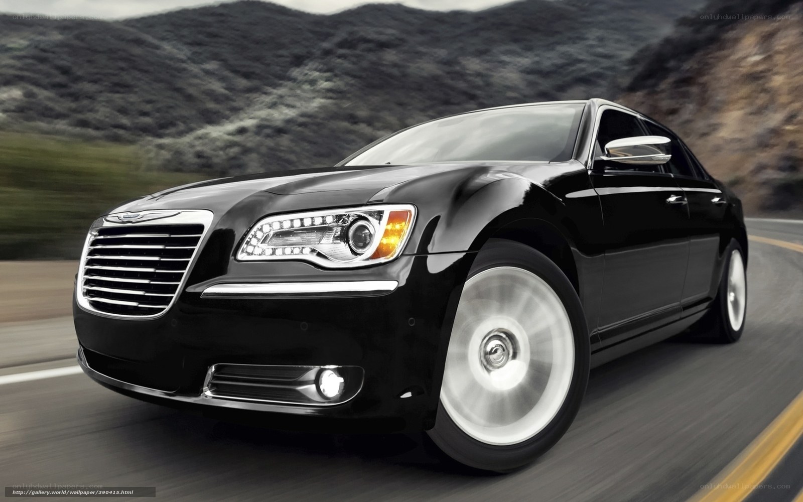 Black Chrysler driving on road