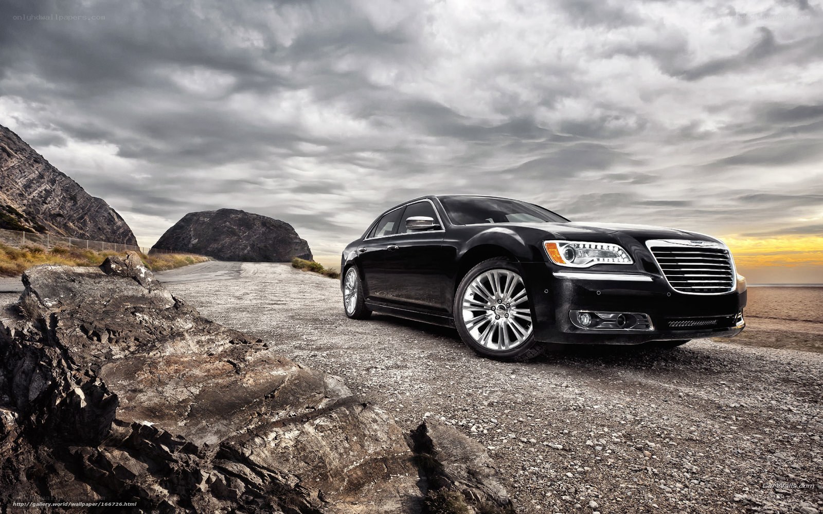 Black Chrysler on a coastal road