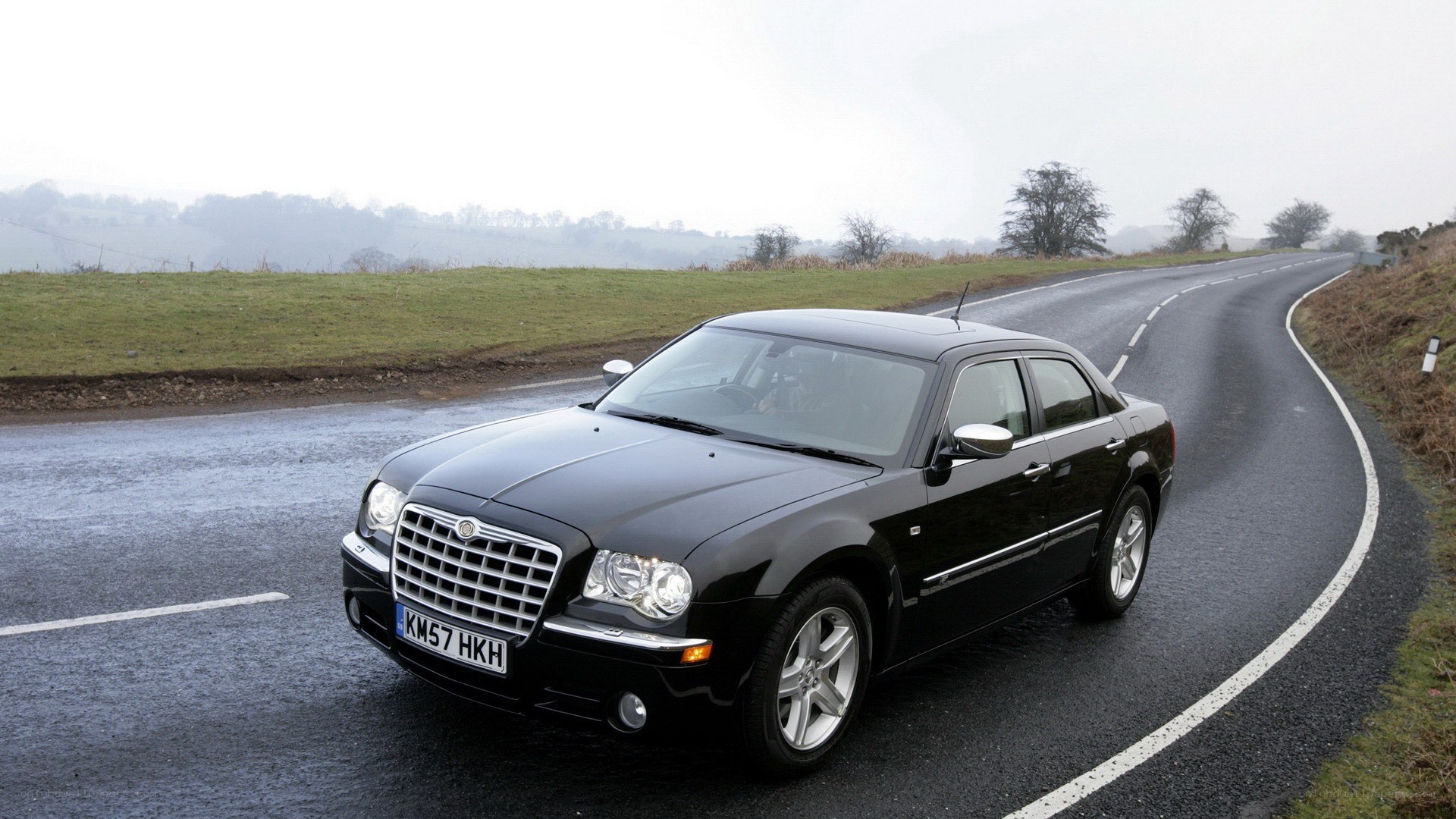 black chrysler on a wet road