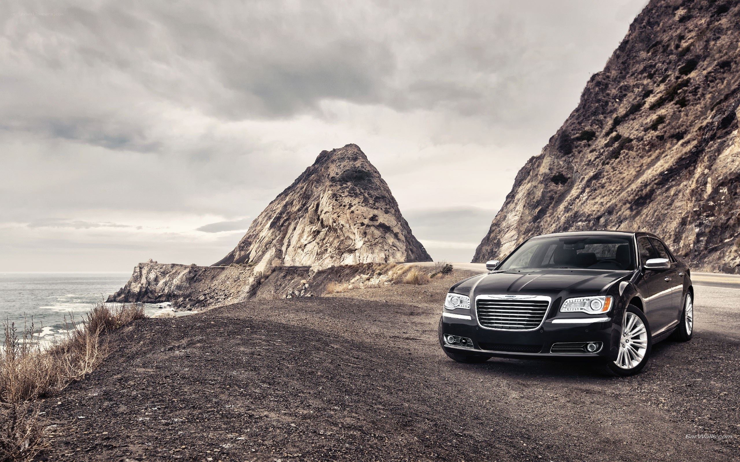 Black Chrysler on coastal road