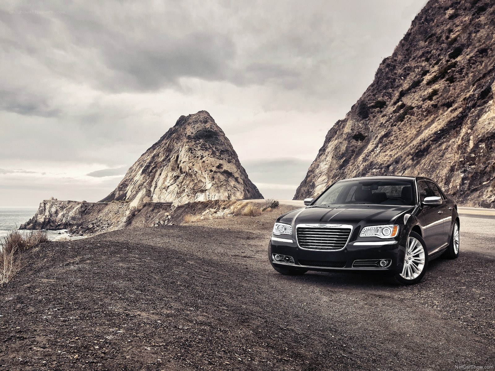 Black Chrysler on coastal road