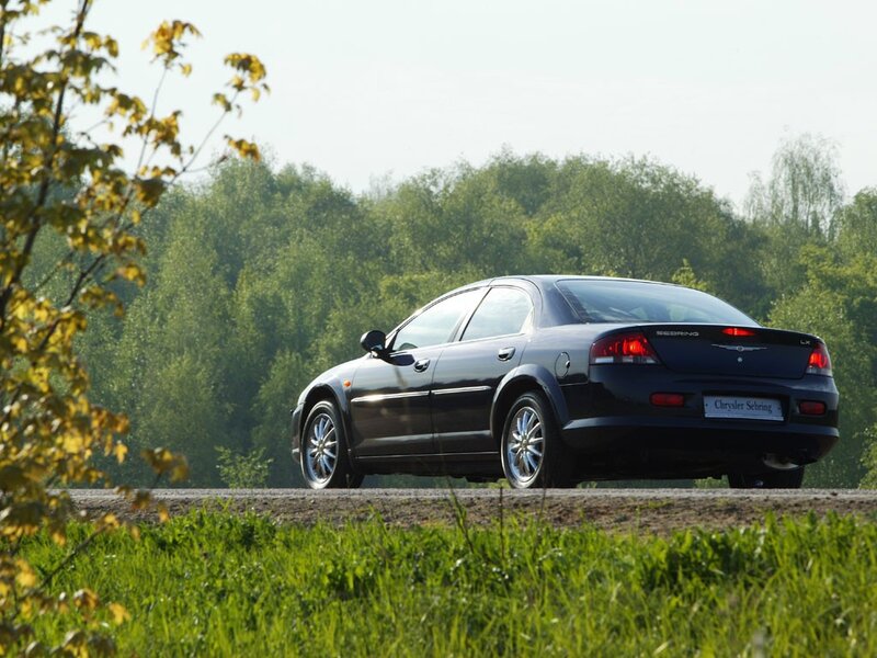 Black Chrysler Sebring on a country road