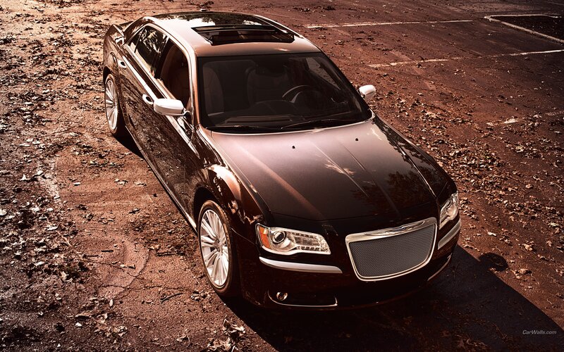 black chrysler sedan on dirt