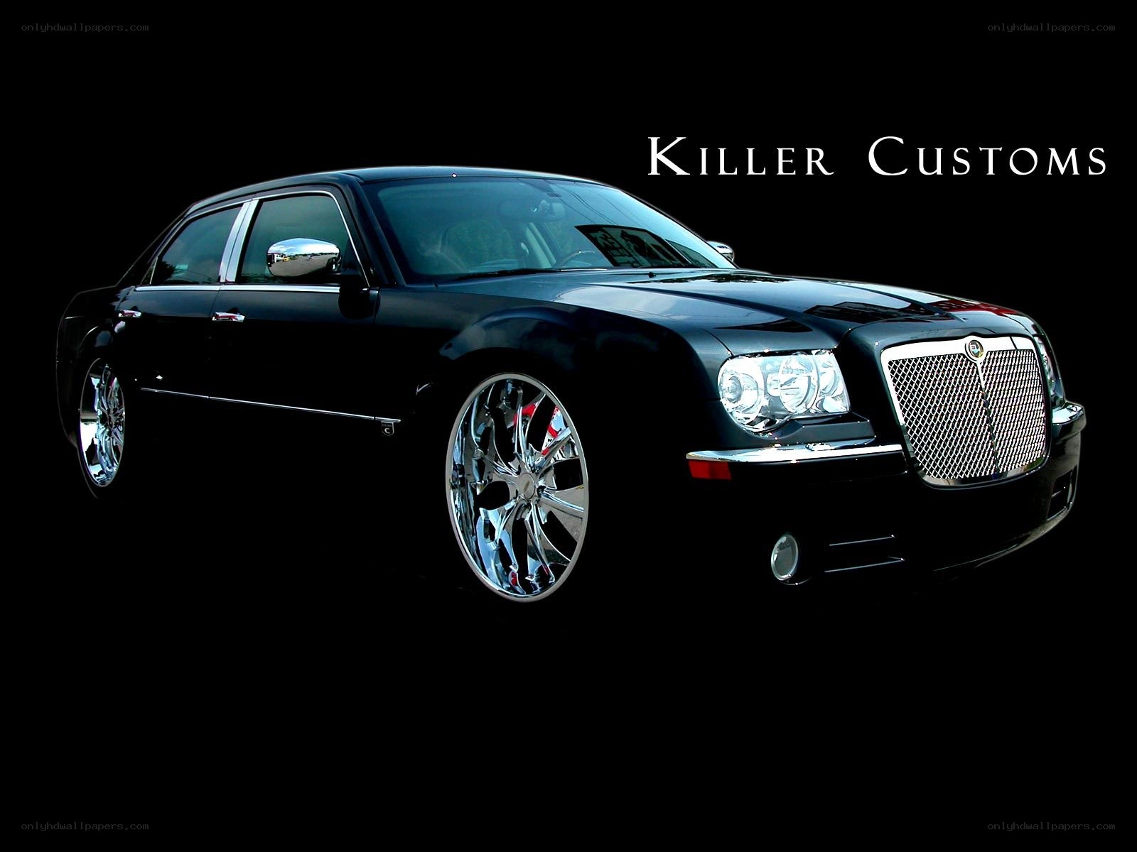 black chrysler sedan with custom wheels