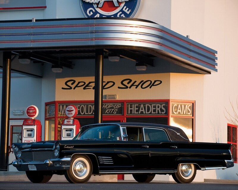 Black classic car at gas station
