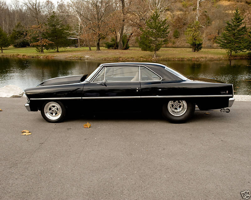 black classic car by a pond