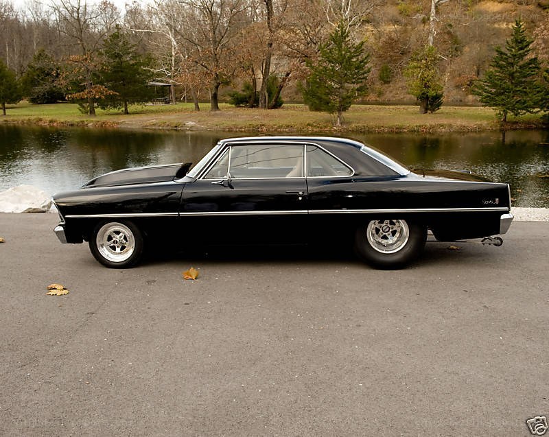black classic car by a pond
