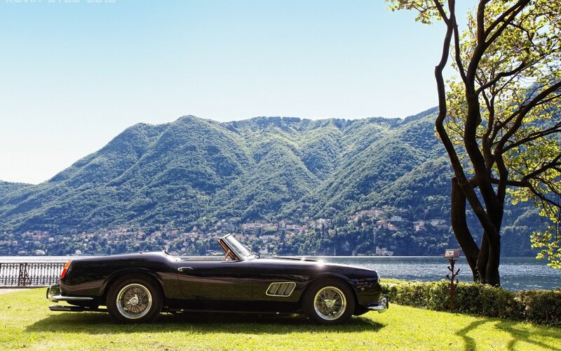 Black classic car by the lake