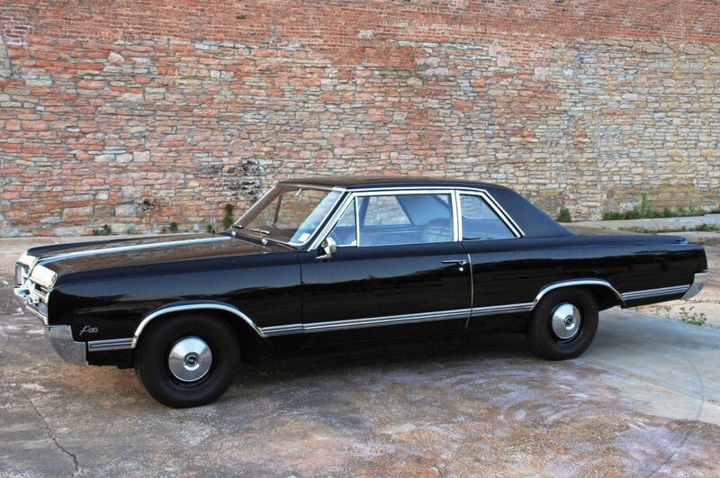 Black Classic Car — Calm, Afternoon, Photograph, Brick Wall, Concrete Ground