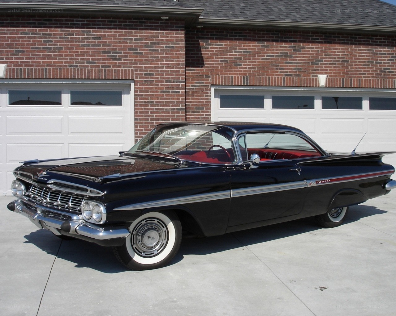Black classic car in driveway