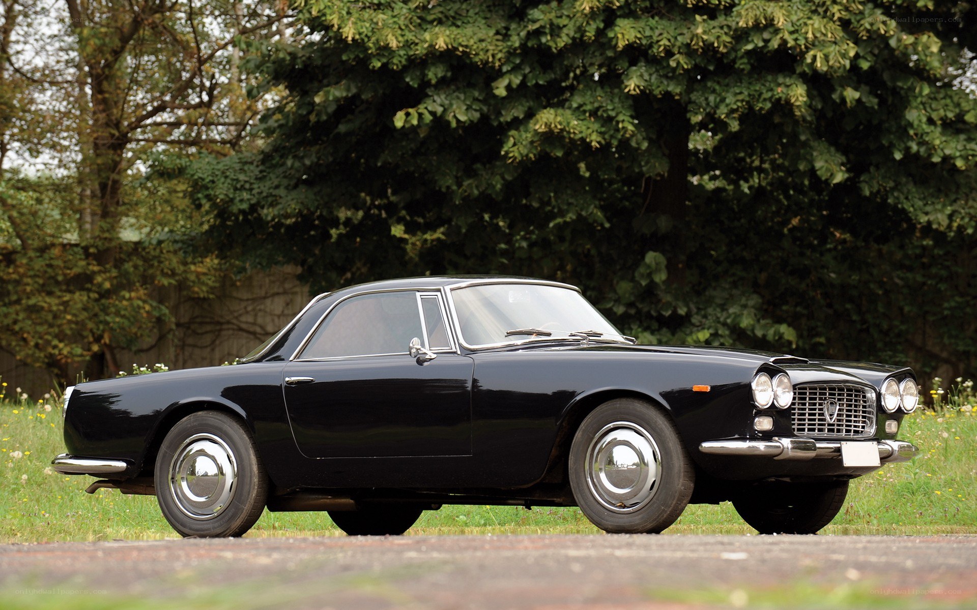 black classic car in field