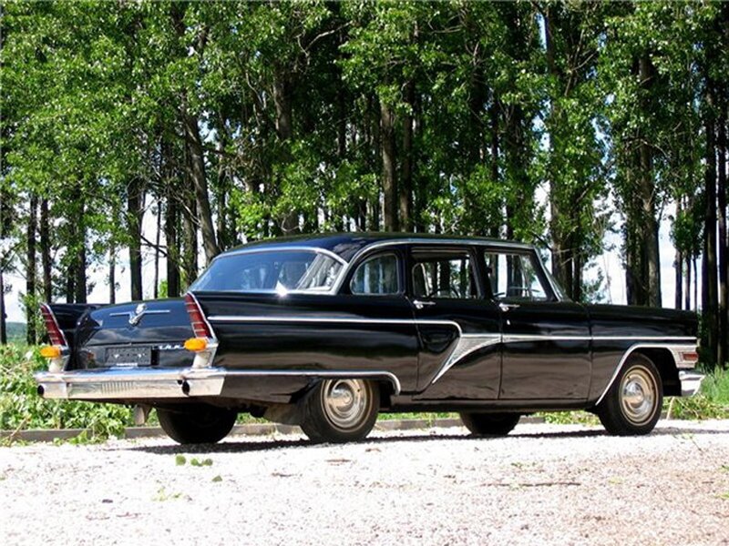 black classic car in forest