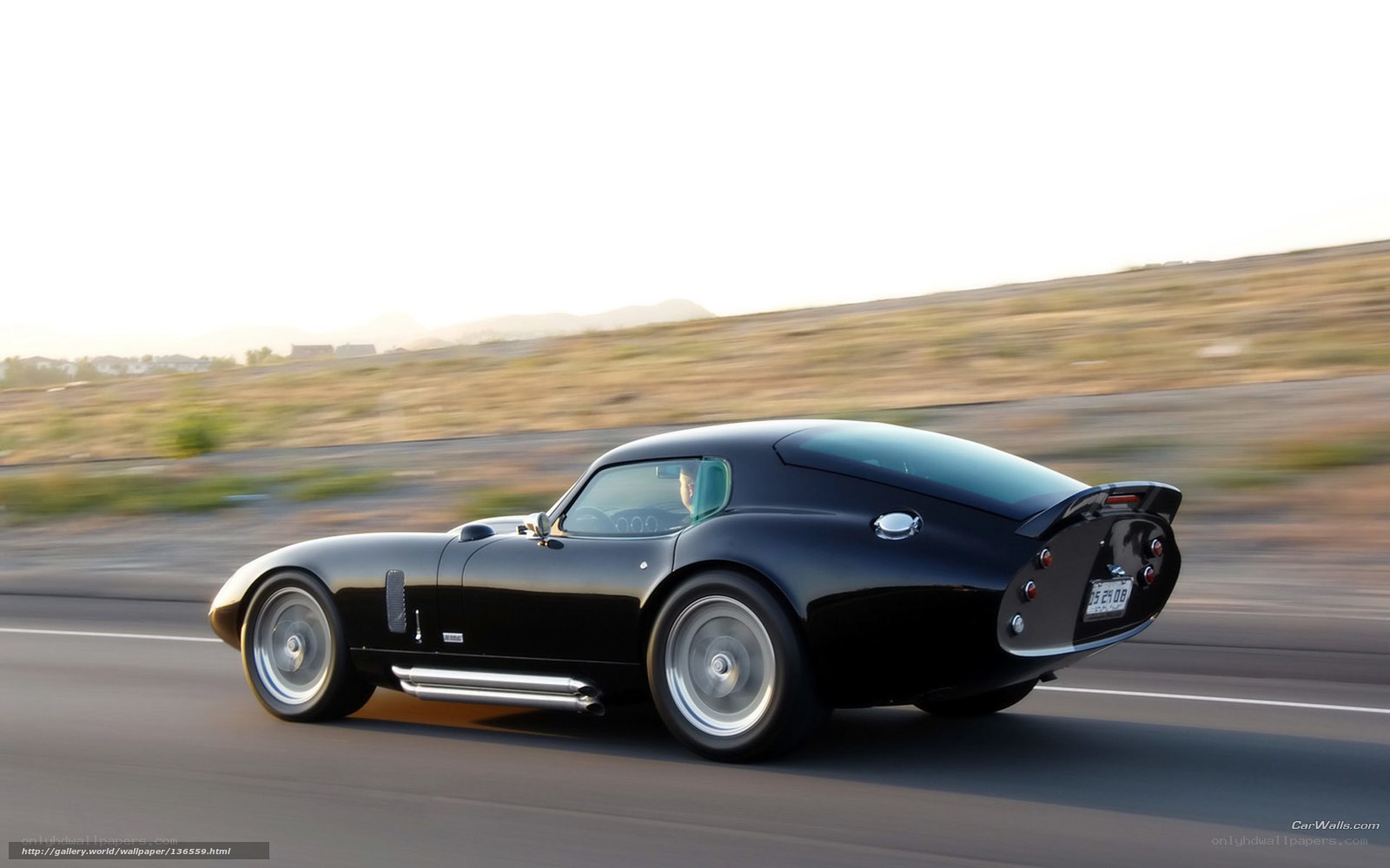 black classic car in motion