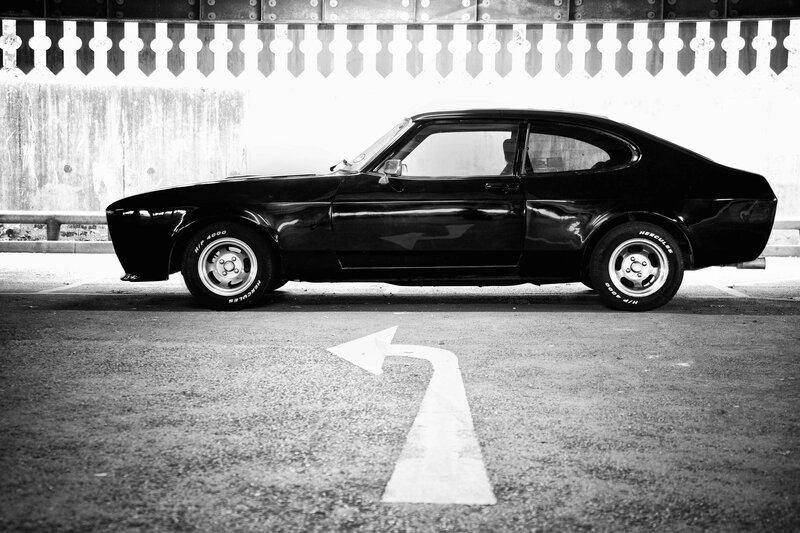 Black classic car in parking garage