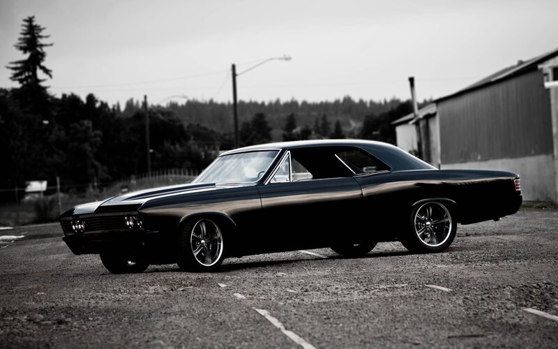 black classic car in parking lot